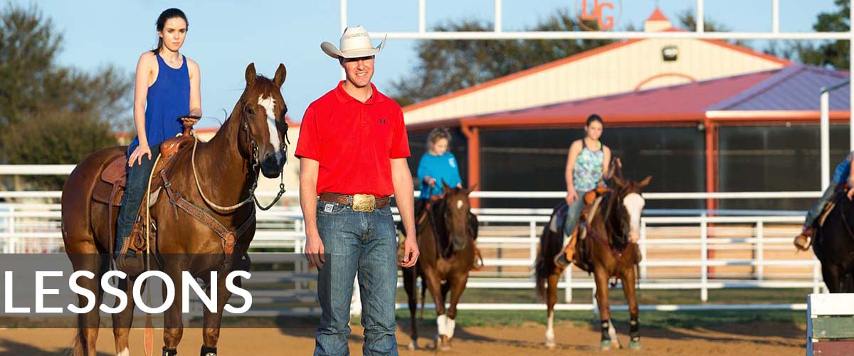 lessons man in red shirt cowboy hat showing pre teen teenager girls how to ride a horse at DG Ranch tx texas